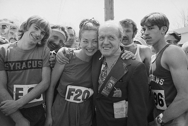 16 Apr 1973, Hopkinton, Massachusetts, USA --- Hopkinton, Mass.: Jock Semple (R) B.A.A., Boston Marathon official, who for years was against women running in the famous Boston Marathon, poses with pretty Katherine Switzer (L) a marathoner from the Central Park A.C., prior to start of the 77th annual race. The 26-mile 385-yd., event was won by Jon Anderson of the Oregon T.C. --- Image by © Bettmann/CORBIS